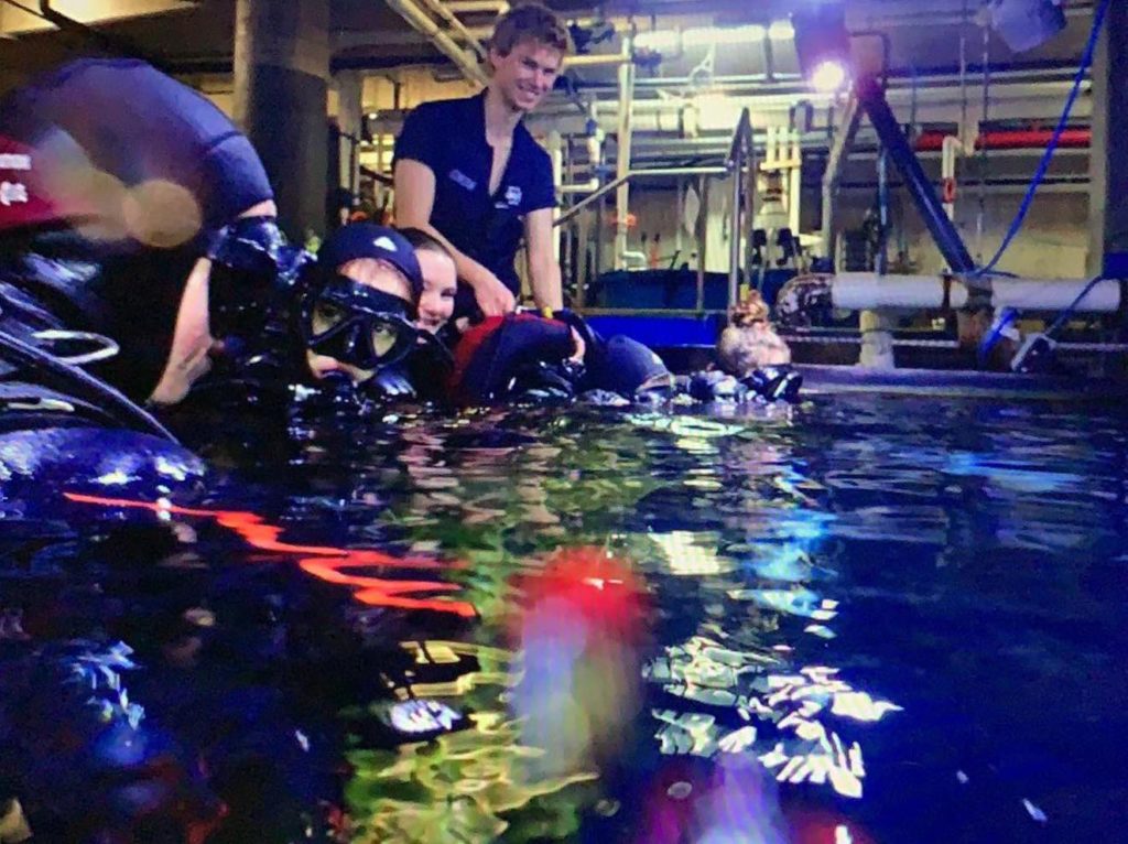 Shark Dive Instructor in the aquarium tank teaching new divers