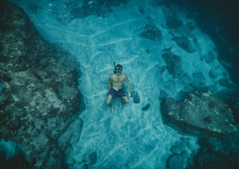 Man showing how to snorkel underwater