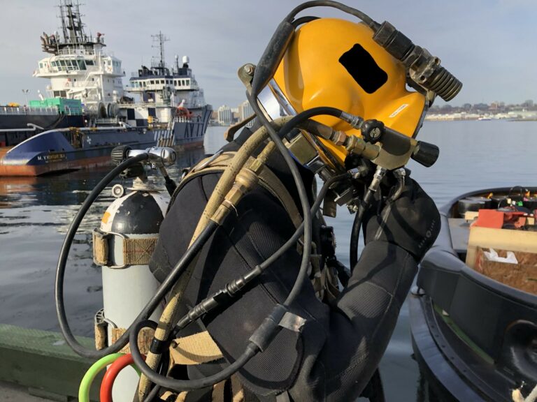 A commercial diver in his equipment including helmet.