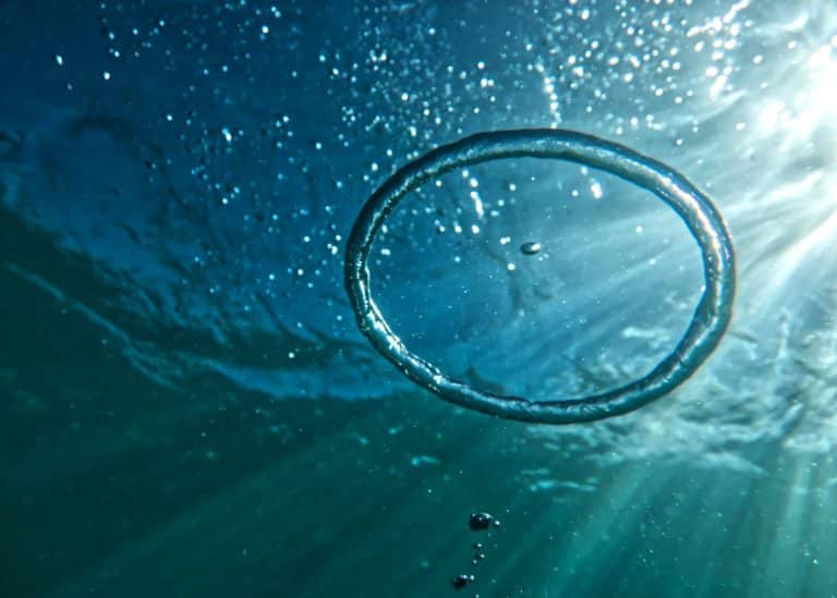 This bubble ring underwater reminds us of a soft contact lens. We want to know more about scuba diving with soft contact lenses.