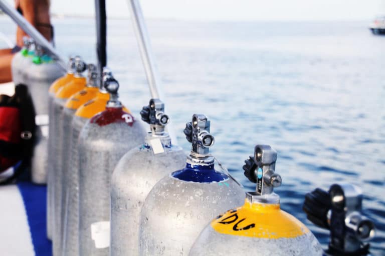 Scuba cylinders on a dive boat. How Many Years Does A Scuba Tank Last?