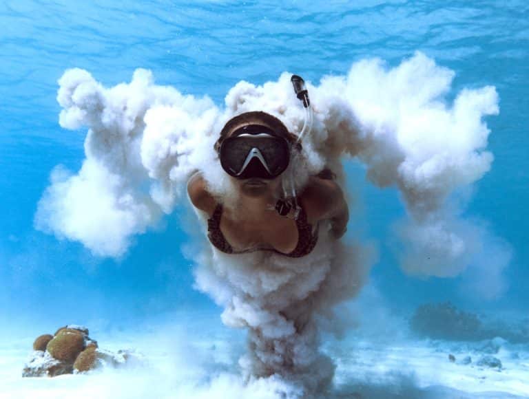 Woman snorkeling underwater using the best reef safe sunscreen