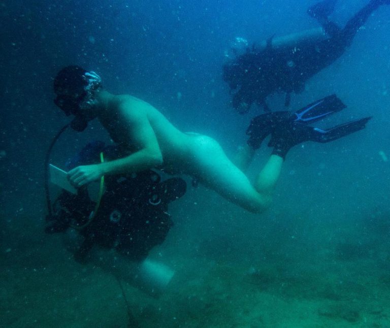 A scuba diver going naked diving for his 100th scuba dive on Koh Tao.