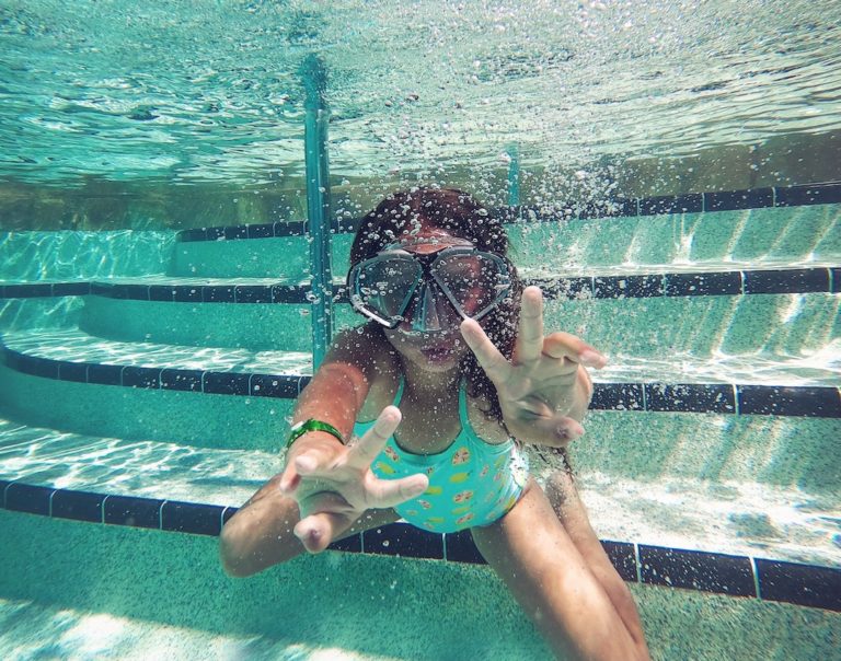 Kid in the swimming pool wearing the best snorkel mask set.